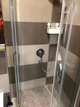Modern shower cabin with glass partition and ceramic tiles. - image 15