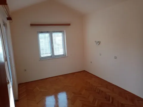An empty room featuring polished parquet flooring and a window. - image 27