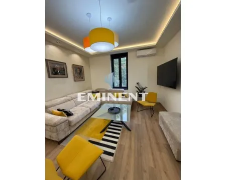 Living room with a sectional sofa, TV, and dining table. - image 2