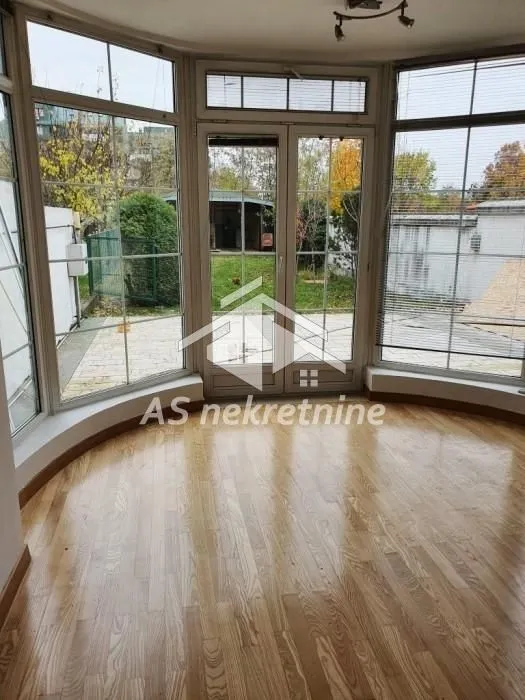 Living room with large windows and a view of the courtyard.