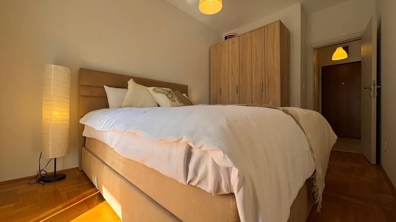 Furnished bedroom with a double bed and wardrobe.