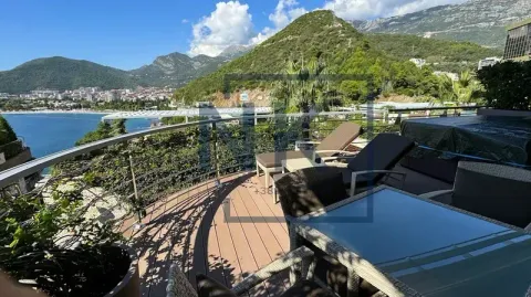 Spacious terrace with outdoor seating and sun loungers offering sea and mountain views. - image 3