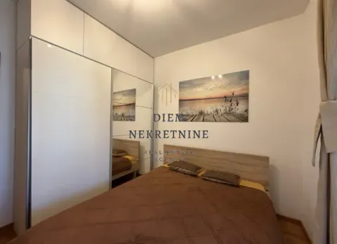 Bedroom with a double bed, large wardrobe, and a water-themed wall art. - image 12