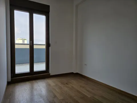 Empty room with wooden flooring and access to the terrace. - image 20
