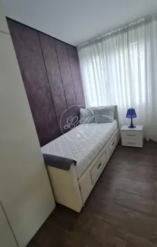 Small bedroom with a bed and a bedside table. - image 9