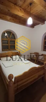 Bedroom with a wooden bed and ceiling. - image 2