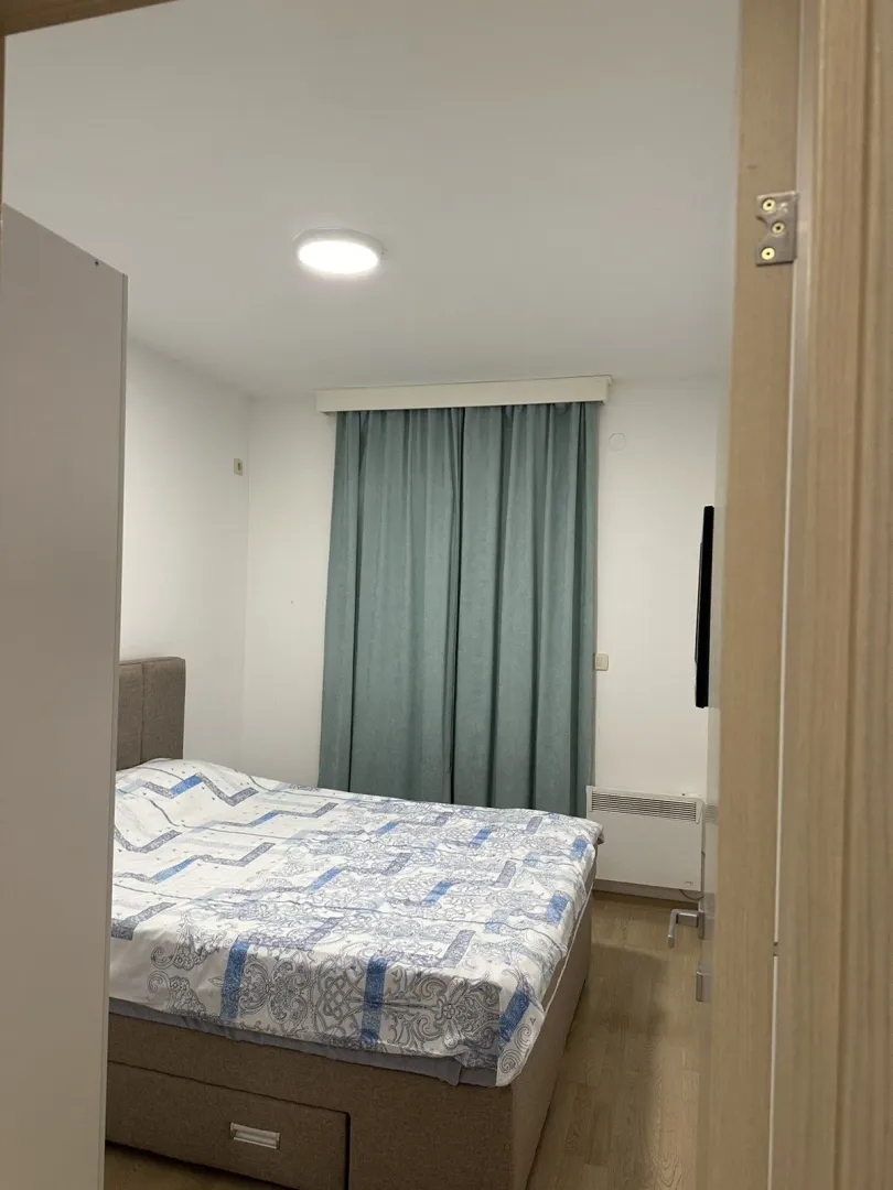 A simply furnished bedroom with a double bed.