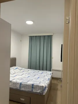A simply furnished bedroom with a double bed. - image 5