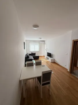 Living room with dining area and sofa. - image 2
