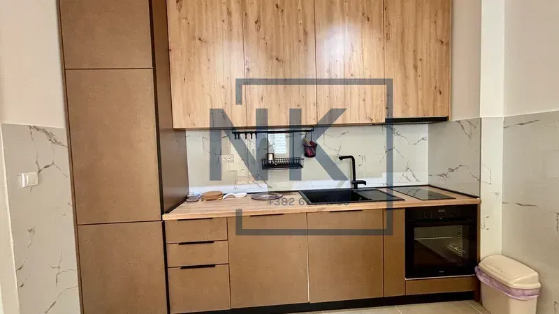 Modern kitchen with wooden cabinets and built-in appliances.