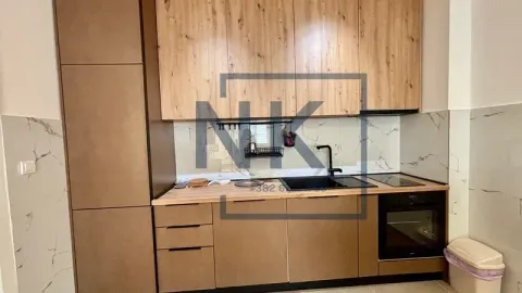 Modern kitchen with wooden cabinets and built-in appliances. - image 3