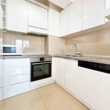 Modern white kitchen with built-in appliances and countertops. - image 2