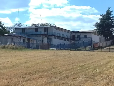 View of the exterior of a commercial building with a grassy area in the foreground. - image 14