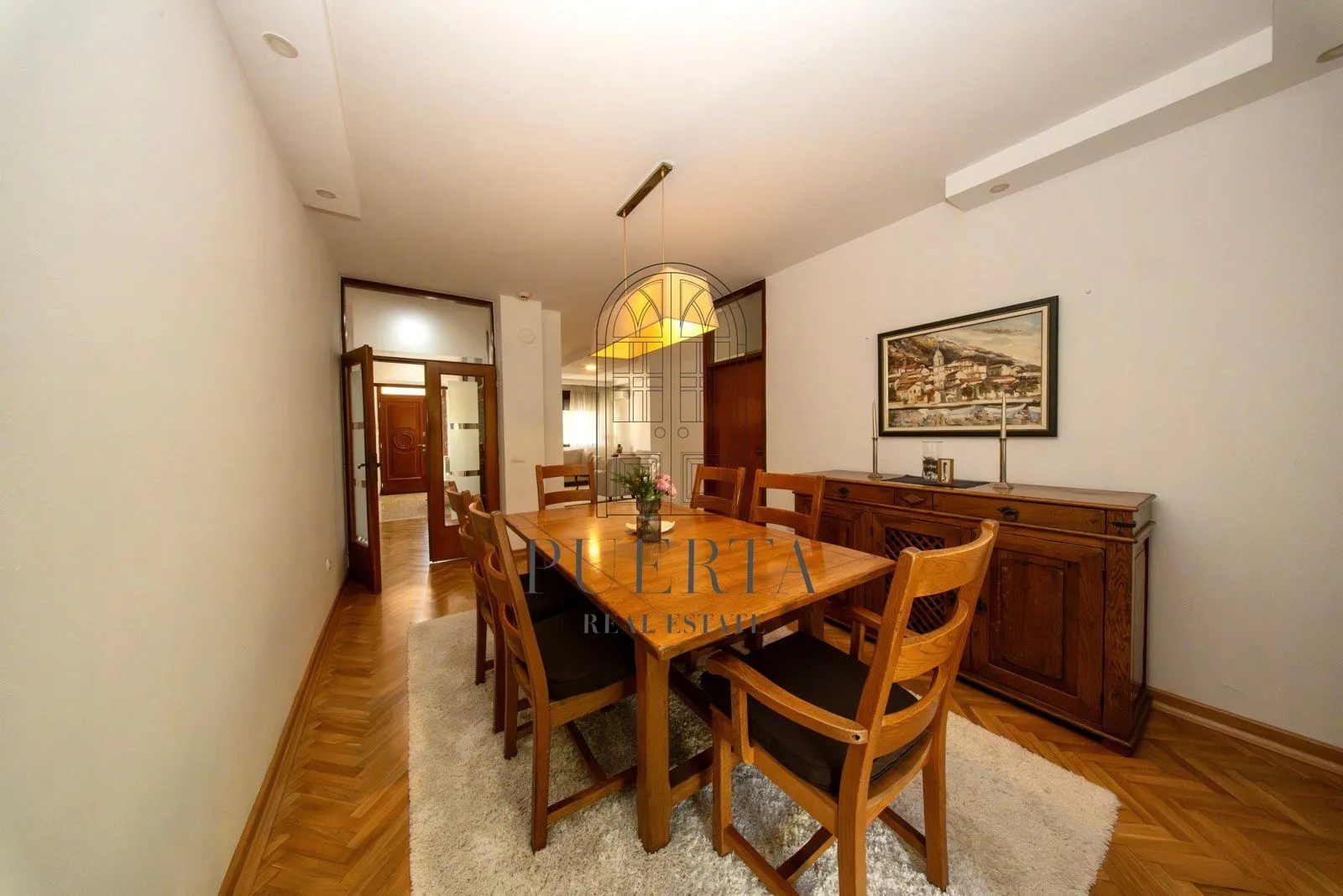 Spacious dining room with a wooden table, chairs, and sideboard.