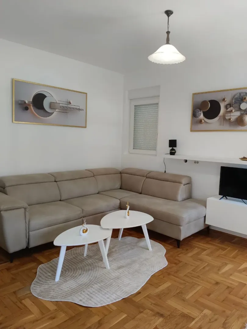 Furnished living room with a sectional sofa, coffee table, and wall art.