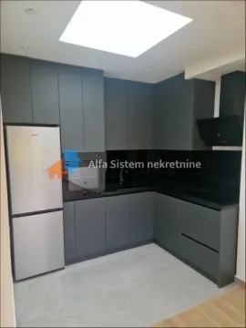 Modern dark-toned kitchen with built-in appliances and a roof skylight. - image 2