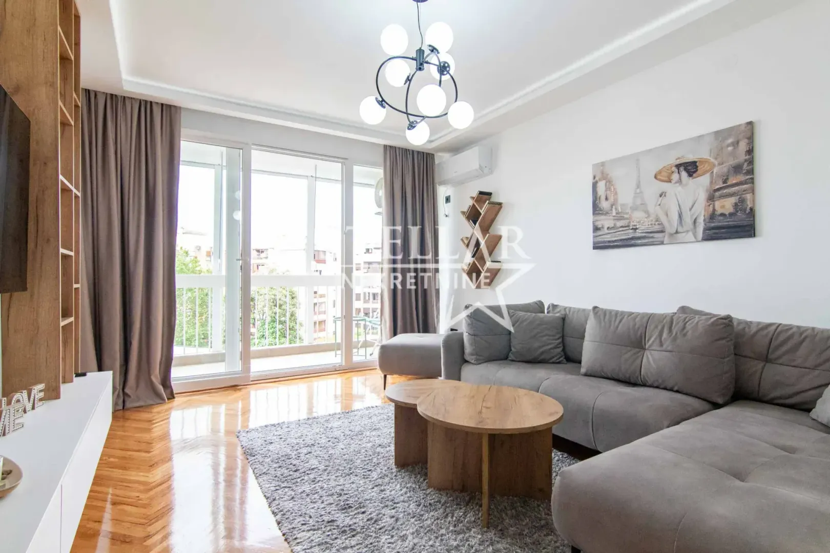 Modern living room with a sectional sofa, wooden coffee table, and access to the terrace.