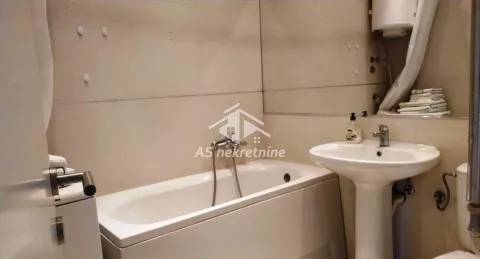 Small bathroom with a bathtub and a sink. - image 18