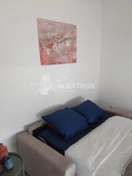 View of a sofa with blue pillows and an artwork on the wall. - image 5