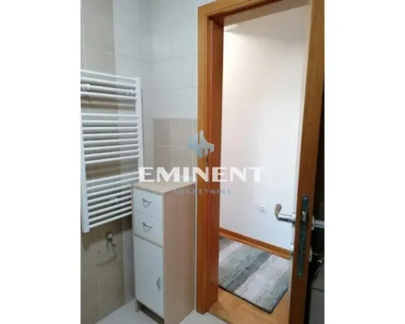 View of the bathroom with a towel radiator and a cabinet. - image 10