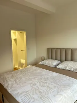 Bedroom with a double bed and an entrance to the walk-in closet. - image 7