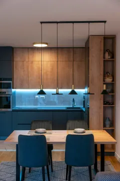 Modern kitchen with wooden elements and a dining table. - image 6