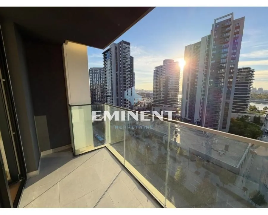 Balcony with a glass railing and city view.