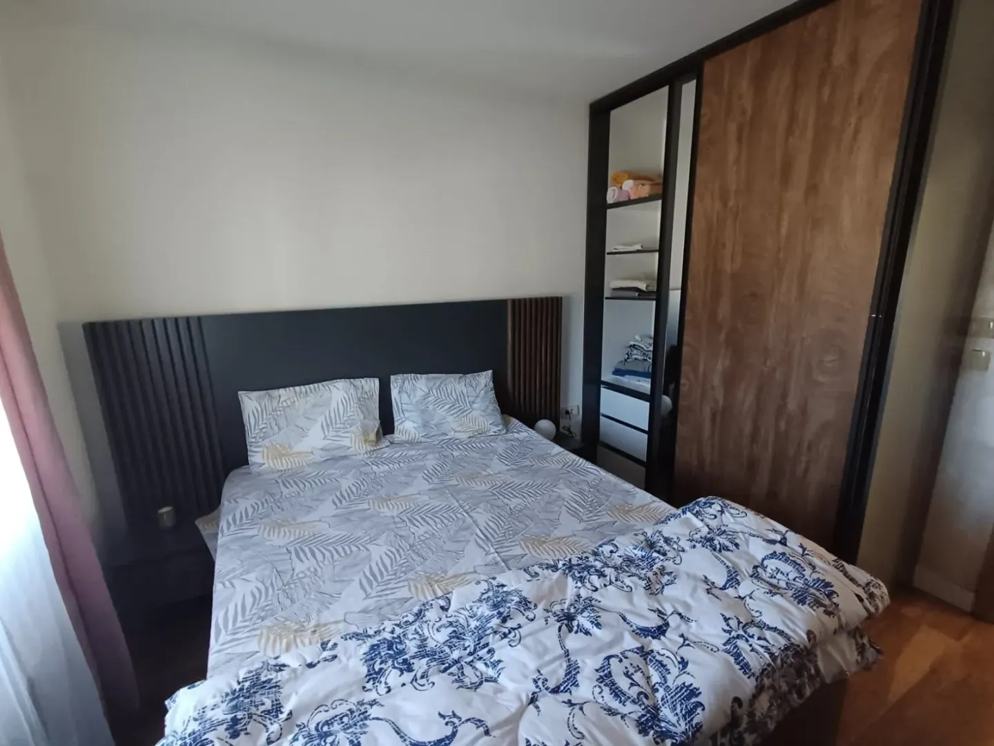 Furnished bedroom with a double bed and built-in wardrobe.