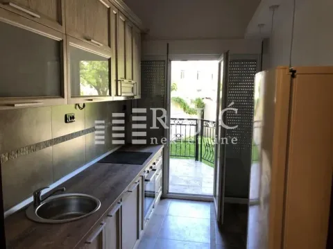 Smaller kitchen with wooden cabinets and access to the terrace. - image 7
