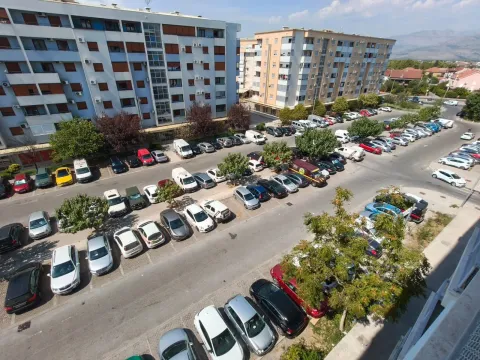 View from the terrace overlooking the parking lot and surrounding residential buildings. - image 12