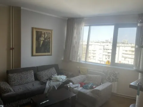 Living room with a sofa set and a large window. - image 2