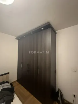 Bedroom featuring a large dark wardrobe with integrated lighting. - image 8