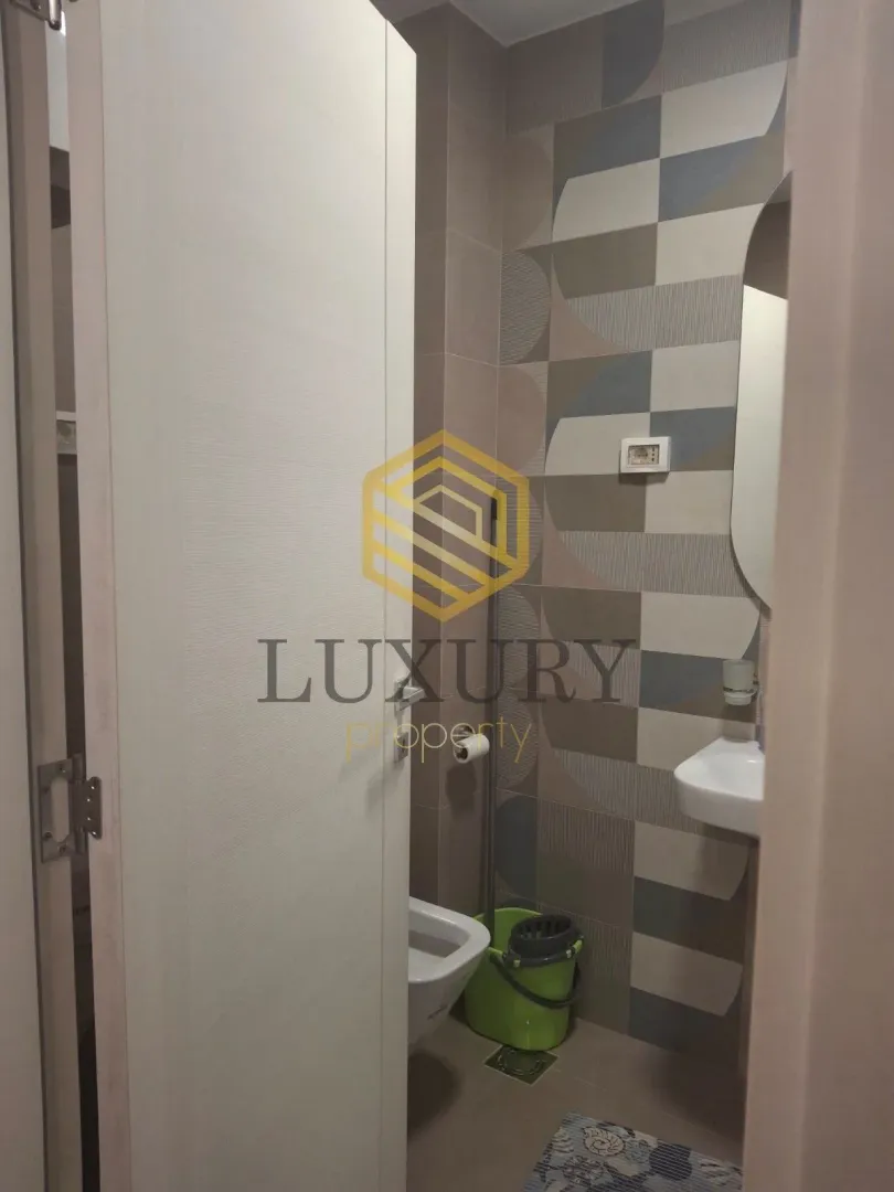 View of a modernly decorated bathroom with a sink and toilet.