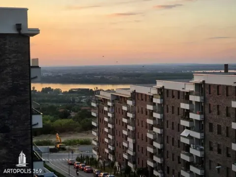 View from the window of the river and surrounding buildings during sunset. - image 2