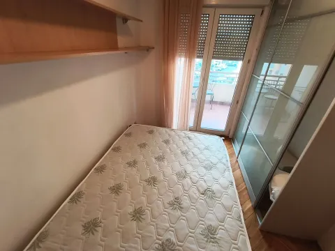Small bedroom with a bed, wardrobe, and access to the terrace. - image 9