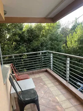A spacious terrace with seating and a view of greenery. - image 10