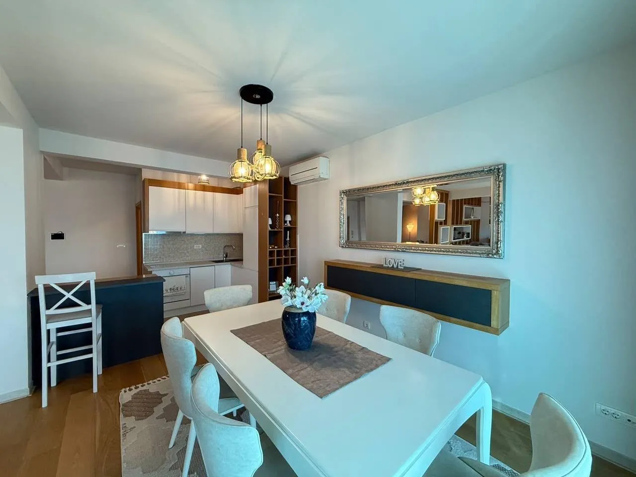 Living room with dining area and kitchen in the background.