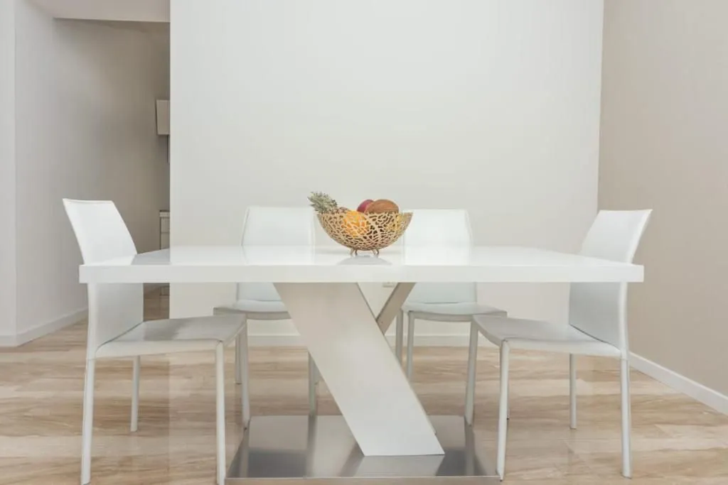 Dining area with a white table and chairs.