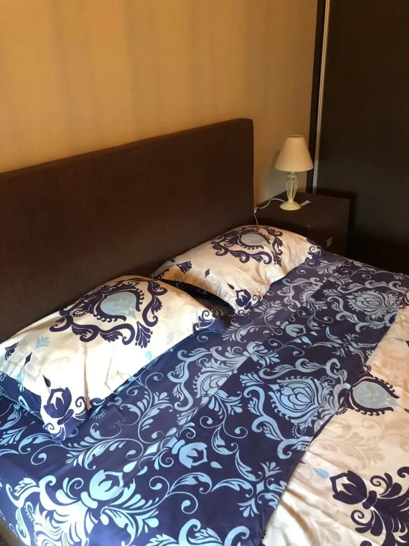 Furnished bedroom with a double bed and a nightstand.