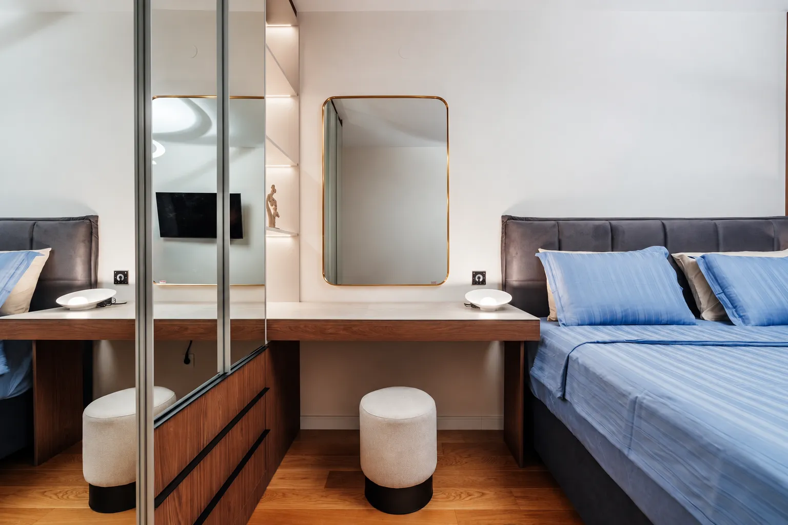 Modern bedroom with a double bed, built-in wardrobe, and vanity desk.