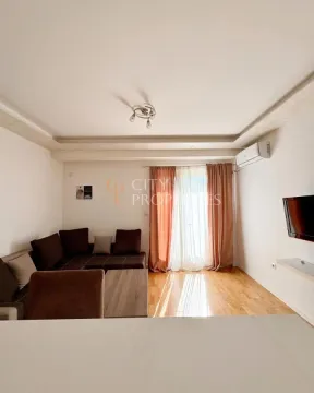 Living room with a sofa, TV, and access to the terrace. - image 10