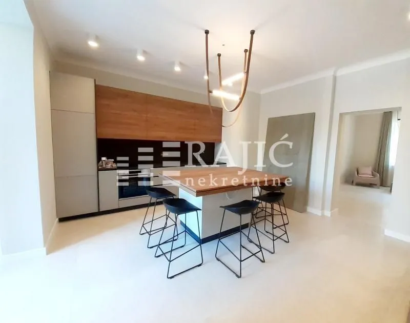 Modern kitchen with an island and bar stools.