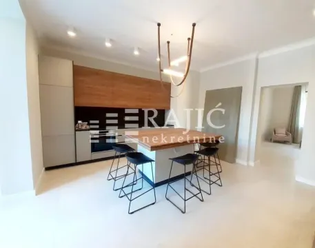Modern kitchen with an island and bar stools. - image 6