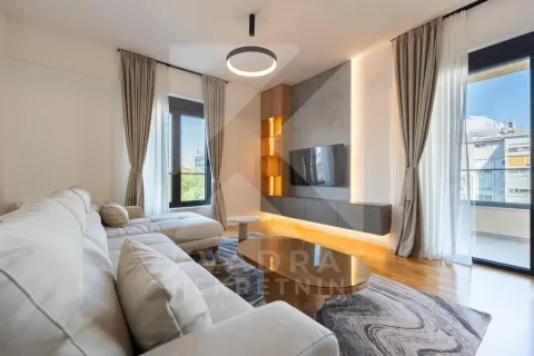 Modern and bright living room with a sofa, TV, and access to the terrace. - image 2