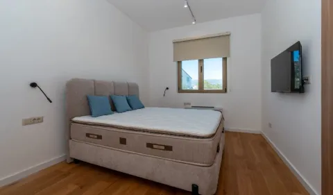 Bedroom with a double bed and a wall-mounted TV. - image 8