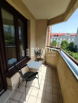 Small furnished balcony with seating furniture. - image 8