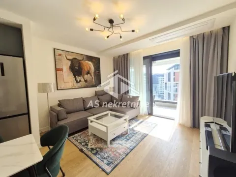Furnished living room with a sofa, coffee table, and access to the terrace. - image 4