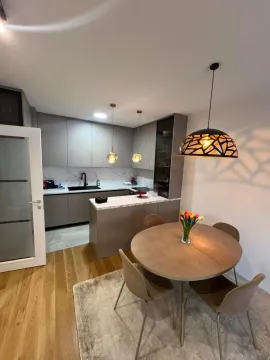 Modern kitchen with dining area and built-in units. - image 5