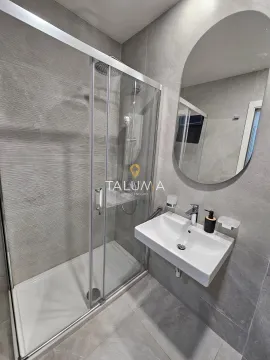 Modernly equipped bathroom with a walk-in shower and washbasin. - image 7