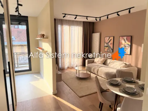 Living room with a sofa, dining table, and access to the terrace. - image 12